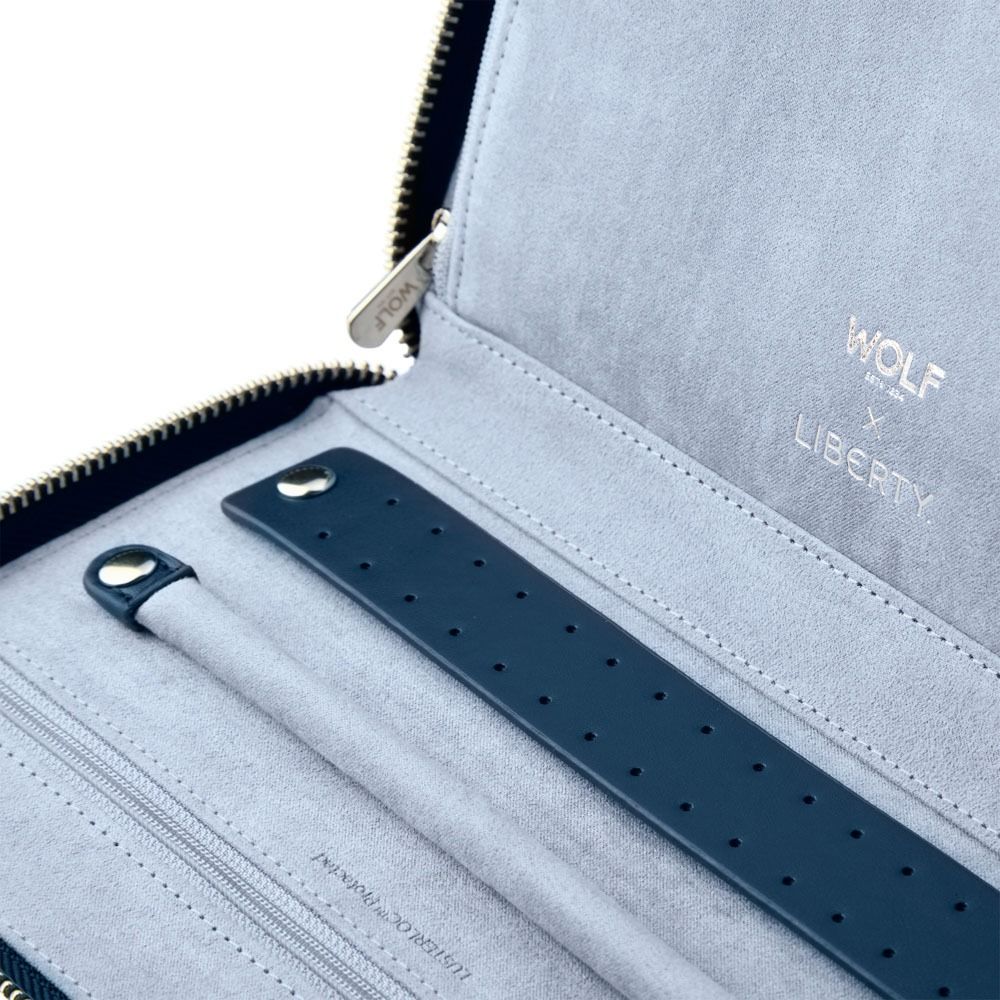 Keep your jewelry secure on the go with the WOLF 1834 X Liberty All Over Ianthe Travel Jewellery Portfolio in Navy. This elegant case features a light grey LusterLoc™ interior embossed with “WOLF x LIBERTY” in gold, a navy blue strap with holes, and a zipper compartment—all thoughtfully designed for organizing and storing your jewellery.