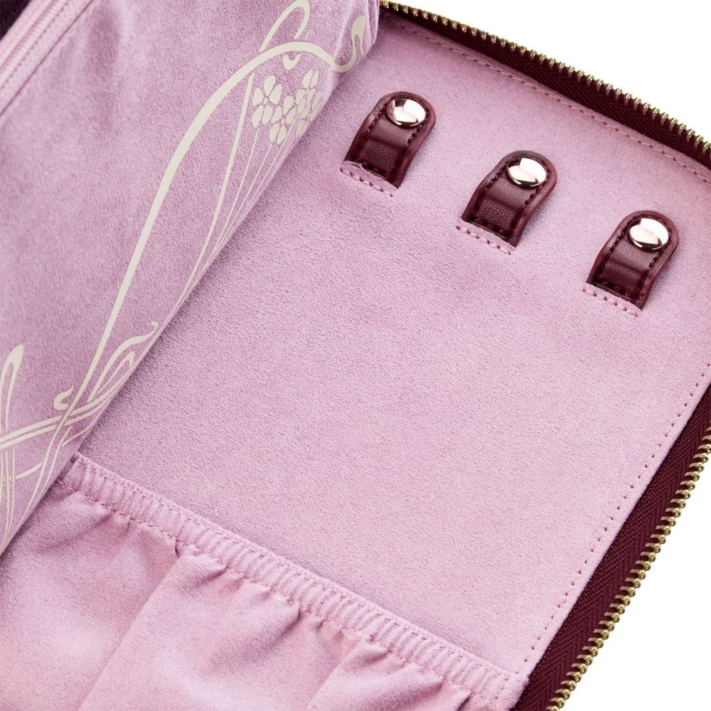 A close-up of the WOLF 1834 X Liberty All Over Ianthe Travel Jewellery Portfolio in Burgundy shows its soft fabric-lined interior, featuring three ring holders with loops and two elastic pockets—all enhanced with LusterLoc™ technology for added protection.