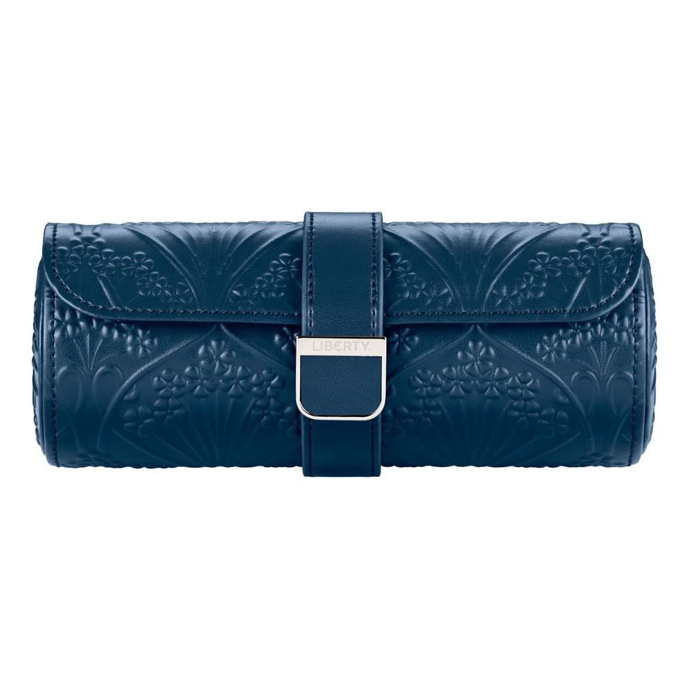 Elevate your style with the WOLF 1834 X Liberty All Over Ianthe Triple Watch Roll Navy—a sophisticated navy leather accessory adorned with embossed floral patterns, a convenient strap, and a silver rectangular clasp engraved with “LIBERTY.” Perfect for pairing with your favorite travel watch storage or leather watch case from WOLF.