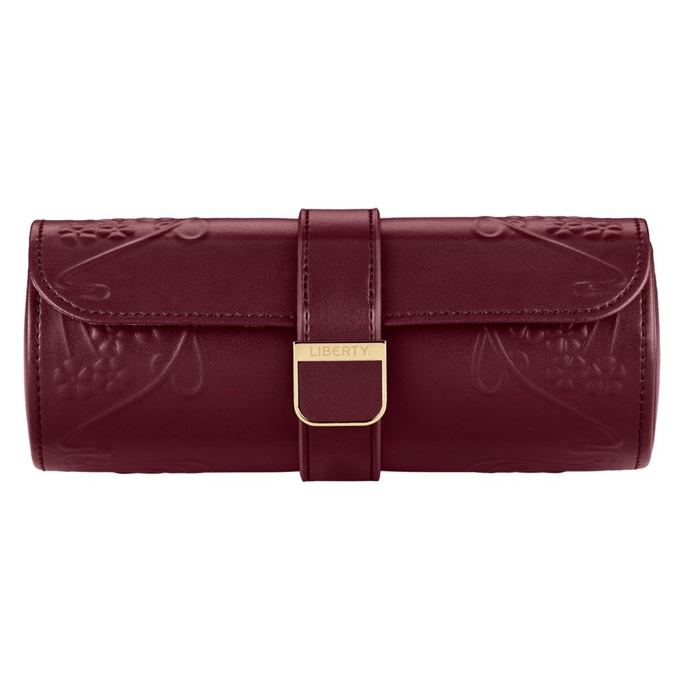 A burgundy leather watch roll from WOLF, crafted in collaboration with Liberty, showcases embossed Ianthe floral patterns and features a secure flap closure with a gold clasp engraved “Liberty.” Inside, find thoughtfully designed compartments for your treasured timepieces—seamlessly combining refined elegance with functional sophistication.