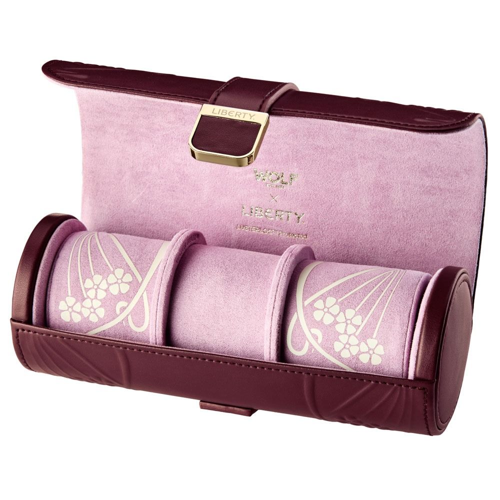 Discover the WOLF 1834 X Liberty All Over Ianthe Triple Watch Roll in Burgundy—an elegant leather travel case from WOLF. Featuring a rich burgundy and pink color palette with sophisticated gold accents, this stylish accessory offers three compartments for your timepieces. The soft pink interior showcases Liberty’s signature Ianthe floral motif, while “WOLF Liberty” is elegantly embossed in gold on the inside lid. With an additional hidden jewelry capsule, this watch roll is perfect for keeping your