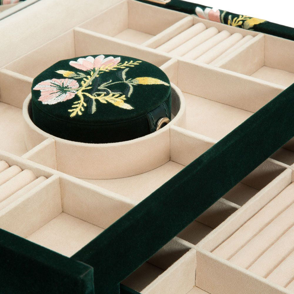 The WOLF 1834 Zoe Large Jewellery Box is a round green velvet container with floral embroidery, featuring beige compartments for jewelry storage and built-in tarnish prevention using LusterLoc™ technology.