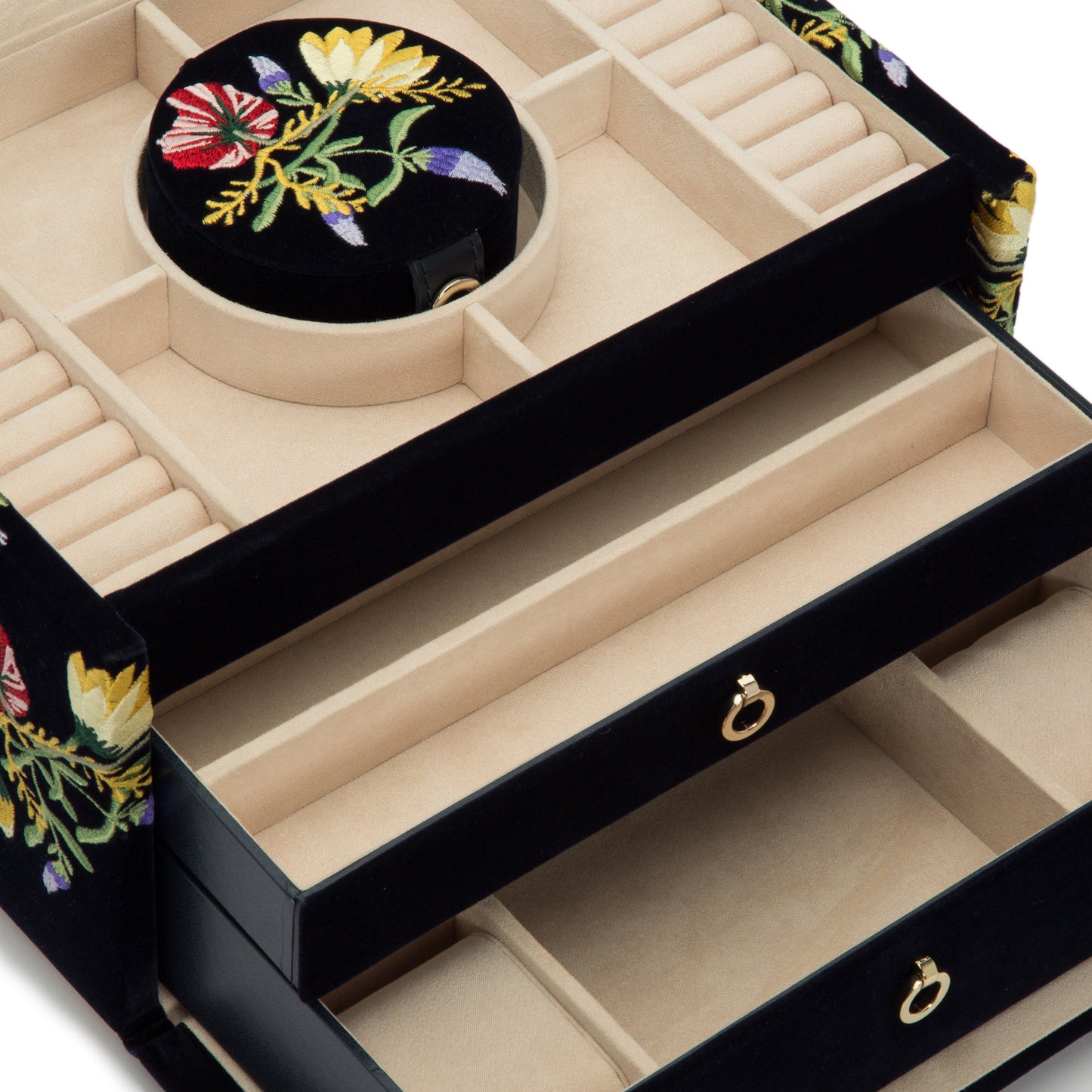 The WOLF 1834 Zoe Medium Jewellery Box from WOLF features open compartments lined with soft fabric for various jewelry pieces and incorporates LusterLoc™ technology to prevent tarnishing. This elegant storage solution is enhanced by a circular section on top and a drawer at the bottom adorned with a golden handle.