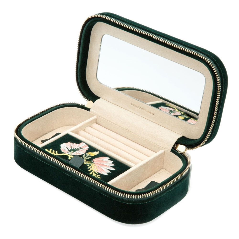 Meet the WOLF 1834 Zoe Travel Zip Case in Forest Green by WOLF—a luxurious velvet jewelry box featuring a light tan interior, built-in mirror inside the lid, ring slots, and clever compartments. It includes a small removable pouch adorned with elegant floral embroidery, making it an ideal choice as both a travel jewelry case and a sophisticated organizer to keep your treasured pieces secure and beautifully displayed.