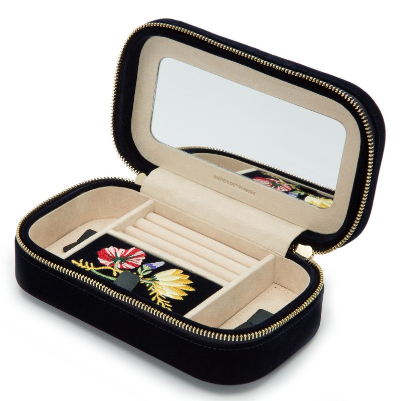 The WOLF 1834 Zoe Travel Zip Case by WOLF is a black, rectangular travel case featuring a zipper closure and an interior lid mirror. It includes beige velvet lining for jewelry storage, compartments specially designed for rings, and a section adorned with colorful floral embroidery. This travel case is crafted to prevent tarnish while you're on the move.