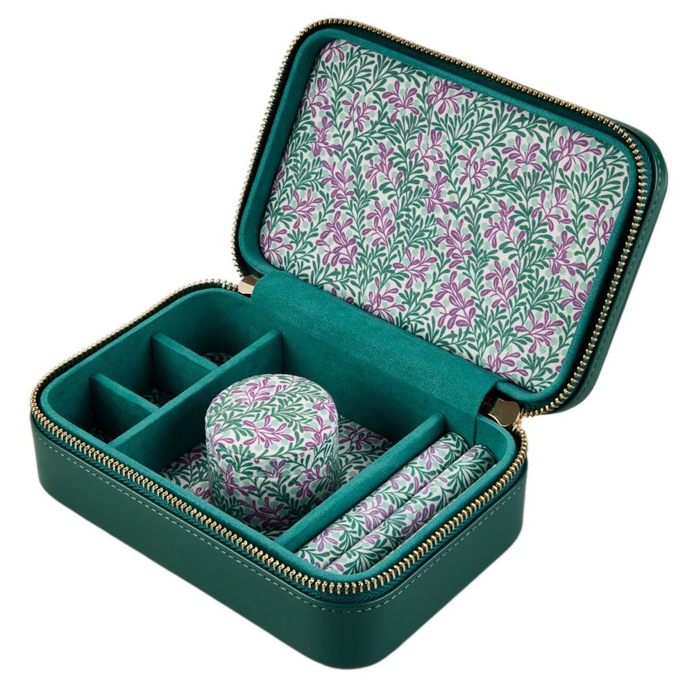 Introducing the WOLF 1834 X Fiona Howard Sophia Travel Zip Case in Forest Green Fruit Botanical—a sophisticated green jewelry box by WOLF, designed with compartments and a zippered closure. Its interior features a beautiful botanical pattern of green leaves and purple flowers, complemented by an anti-tarnish lining to keep your treasured jewelry safe and protected on the go.