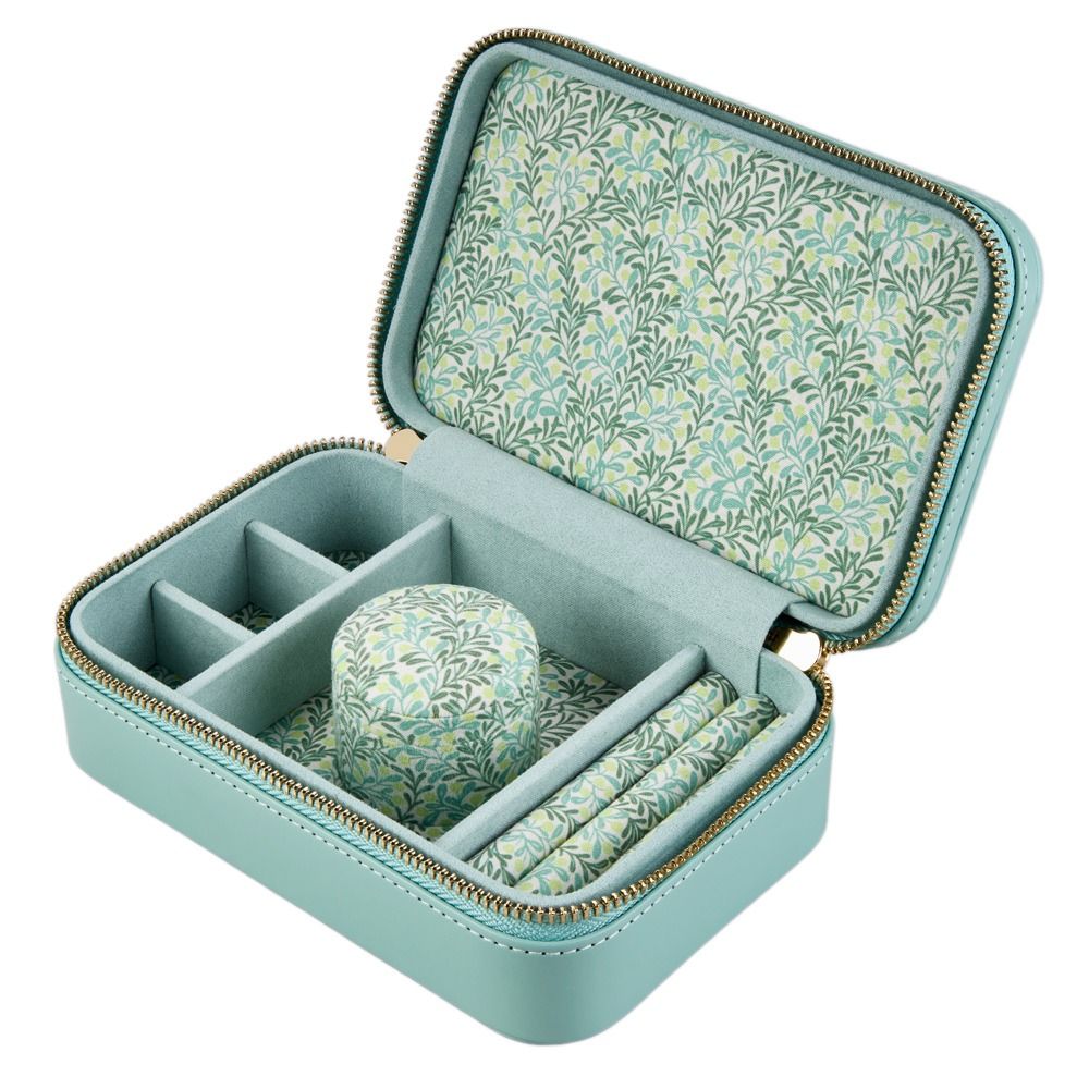 A botanical-inspired travel zip case in light jade blue from WOLF, crafted in diamond-quilted leather and lined with a Fiona Howard fruit and floral print. It features several compartments, a ring holder, a padded cylindrical cushion, and a zippered closure—all neatly organized inside its tarnish-resistant interior to keep your jewelry looking its best.