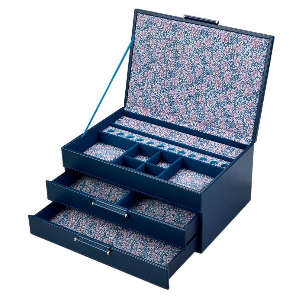 Discover the WOLF 1834 X Fiona Howard Sophia Jewellery Box With Drawers in Indigo Fruit Botanical style—a luxurious blue jewellery box by WOLF. It features an upright lid secured with a blue ribbon, revealing a floral-patterned interior with anti-tarnish lining. Three spacious drawers, each with dedicated compartments, are partially open to display thoughtfully organized storage spaces designed to keep your precious treasures safe and beautifully arranged.