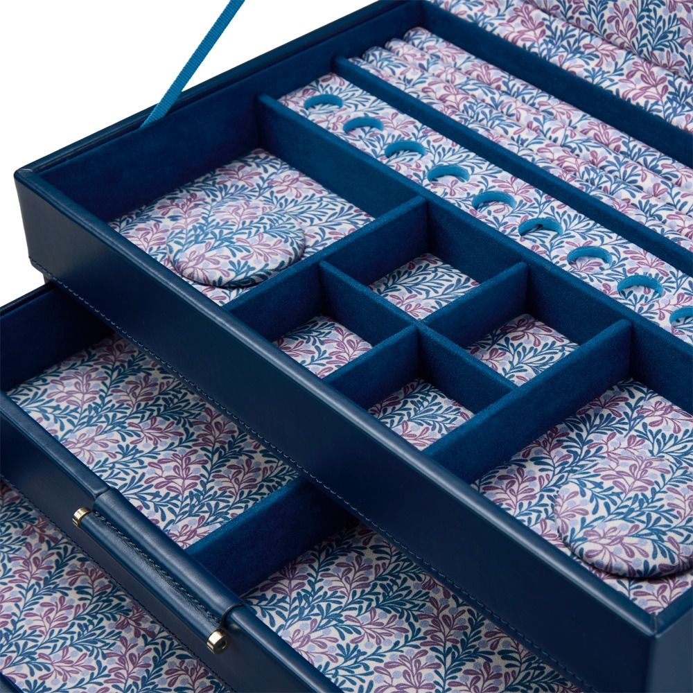 The WOLF 1834 x Fiona Howard Sophia Jewellery Box With Drawers in Indigo Fruit Botanical style features an open leather design with blue edges, multiple compartments, and a decorative anti-tarnish floral interior lining in shades of blue, purple, and pink.