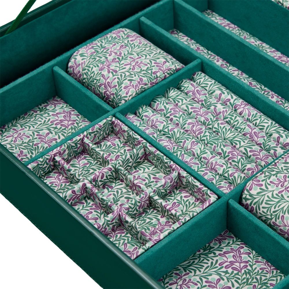 The WOLF 1834 X Fiona Howard Botanical Jewellery Box With Window by WOLF is a green leather case with dividers, featuring an anti-tarnish lining and neatly arranged fabric sections adorned with a white background and green and purple floral patterns.