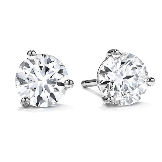 A pair of stunning Hearts On Fire Three-Prong Stud Earrings set with round diamonds, featuring silver prongs and elegantly displayed against a white background.