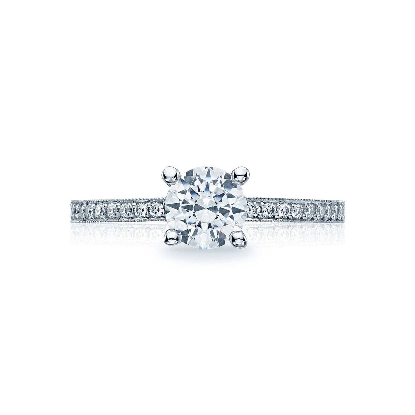The Tacori Semi Mount Sculpted Crescent engagement ring features a classic solitaire design, with an 18K white gold band adorned with smaller diamonds to enhance its brilliance. At the center sits a large round brilliant diamond, creating an exquisite focal point. This stunning piece is elegantly showcased against a plain white background.