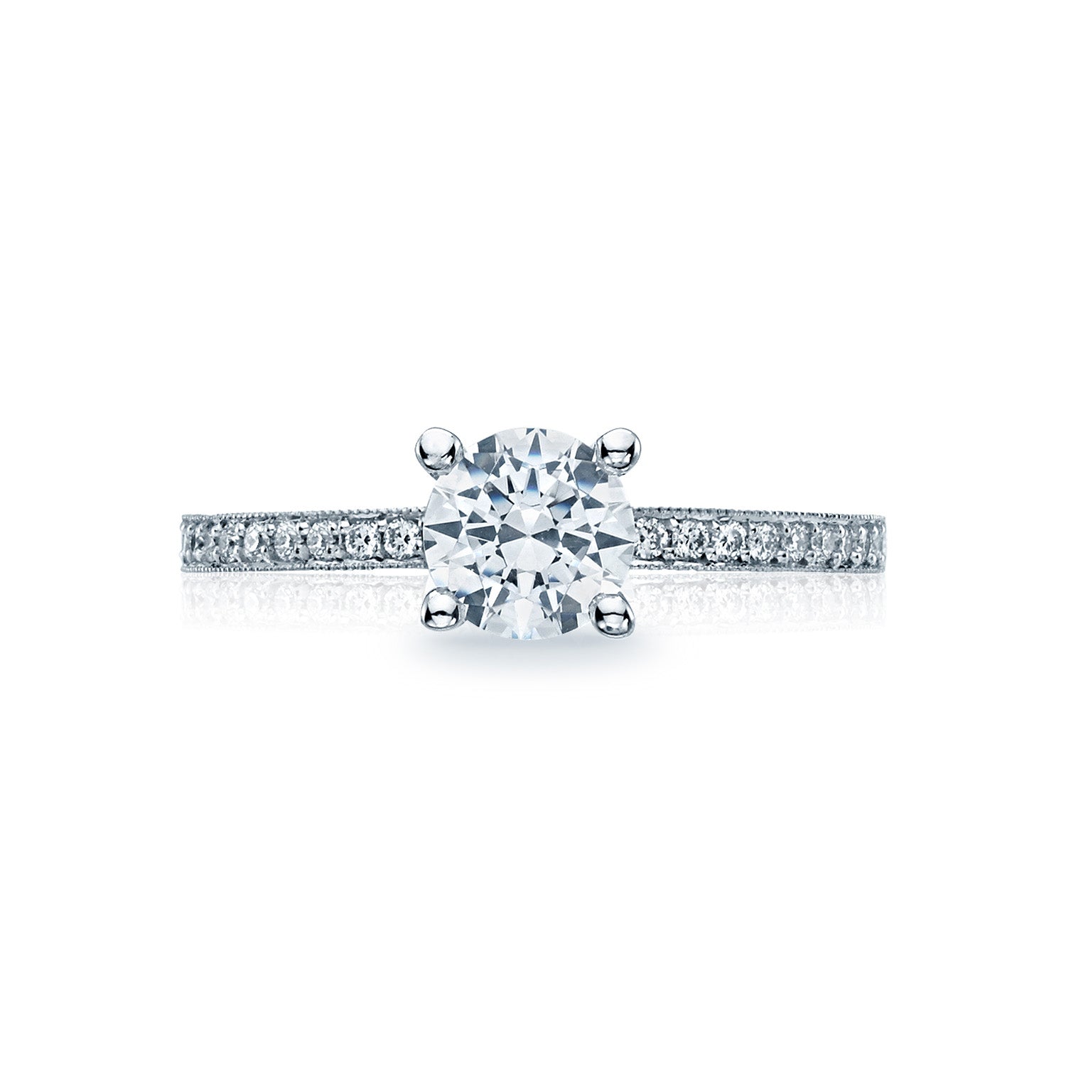 The Tacori Semi Mount Sculpted Crescent engagement ring features a classic solitaire design, with an 18K white gold band adorned with smaller diamonds to enhance its brilliance. At the center sits a large round brilliant diamond, creating an exquisite focal point. This stunning piece is elegantly showcased against a plain white background.
