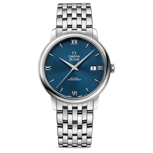 The OMEGA De Ville Prestige Co-Axial Chronometer 39.5mm Watch by OMEGA features a silver stainless steel case with a polished bracelet. Its captivating blue dial showcases Roman numerals and incorporates a date display at the 3 o'clock position, epitomizing luxury timepieces.
