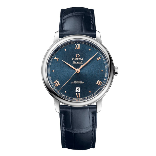 Discover the sophisticated allure of the OMEGA De Ville Prestige Co-Axial Chronometer 39.5mm Watch from OMEGA, featuring a blue textured dial with silver Roman numerals and rose gold accents. It's driven by the Co-Axial Calibre 2500, includes a date window at 6 o'clock, and is complemented by a polished stainless steel case and blue leather strap.