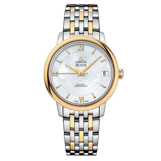 The OMEGA De Ville Prestige Co-Axial Chronometer 32.7mm Watch boasts a luxurious design with a two-tone metal band in silver and gold. Its round face displays Roman numerals and the "OMEGA" brand name, featuring a date display at the 3 o'clock position on a white dial with elegant gold accents.