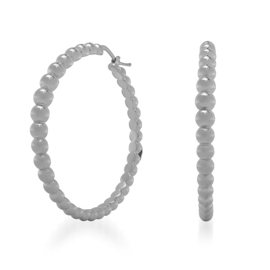 Raffi&Co.® 18K White Gold Hoop Earrings are highlighted against a simple white backdrop. These luxurious earrings by Raffi&Co, featuring a delicate beaded design, are displayed from side and front angles to accentuate their round form and refined texture, capturing elegance in every detail.