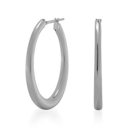 Introducing the Raffi&Co.® 18K White Gold Hoop Earrings—a pair of sleek, shiny silver hoops crafted from luxurious 18K white gold. One earring is displayed face-on, emphasizing its elegant circular shape, while the other is showcased from the side to highlight its thin profile. Experience the refinement and elegance of luxury jewelry with these exquisite hoops by Raffi&Co.