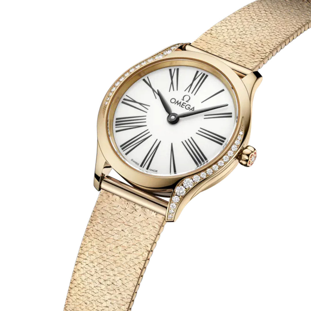 The OMEGA De Ville Mini Tresor Quartz 26mm Watch features a white dial with black Roman numerals, diamond-accented bezel, and a textured Moonshine™ Gold strap, offering an elegant and minimalist design.