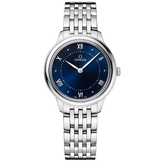 The OMEGA De Ville Prestige Quartz 30mm Watch features a polished stainless steel bracelet, PVD blue dial with silver Roman numerals at 3, 6, 9, and 12 o’clock, and elegant silver hands.