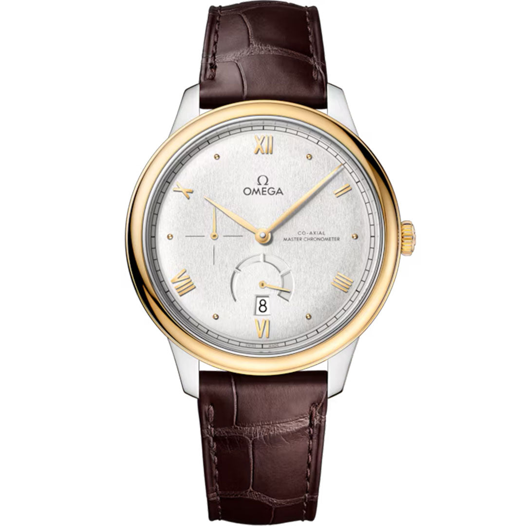The OMEGA De Ville Prestige Co-Axial Master Chronometer 41mm features a silver dial, 18K yellow gold bezel, Roman numerals, date at 6 o'clock, and brown leather strap. Gold-toned hands and markers complete this luxury OMEGA watch.