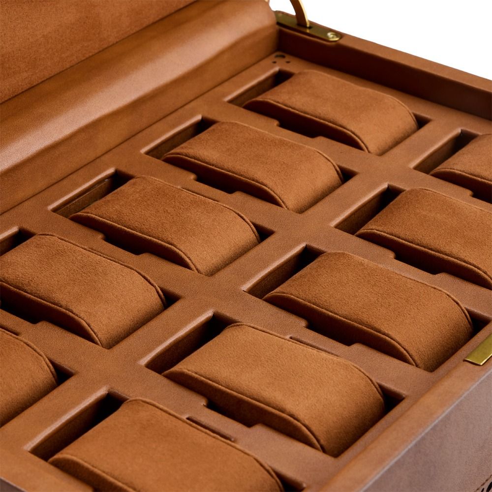 A close-up of the empty WOLF 1834 Brogue 10 Piece Watch Box in Burnished Brown, an open vegan leather case by WOLF featuring ten cushioned compartments for storing watches.