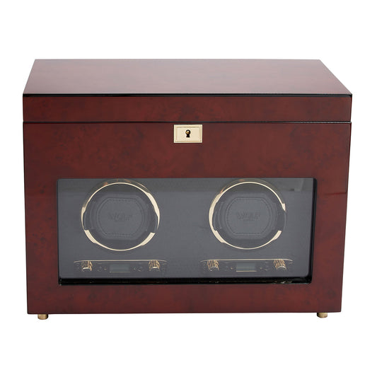 The WOLF 1834 Savoy Double Winder With Storage, crafted by WOLF, showcases an exquisite design in burl wood with a glossy brown finish and a glass front. Inside, it features two circular holders for securely storing watches. The elegant piece is further enhanced by a gold-toned lock on top.