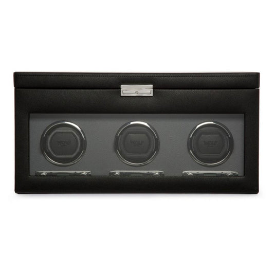 The WOLF 1834 Viceroy Triple Watch Winder with Storage boasts a sophisticated black leather design and a transparent front panel that elegantly displays three circular watch holders. Featuring patented innovation in rotation options, it also includes a metallic latch at the top for enhanced style and functionality.