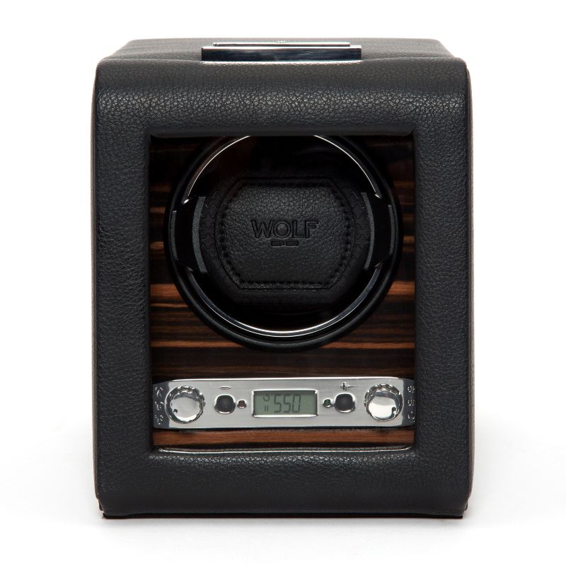 A WOLF 1834 Roadster Single Winder, crafted with leather and wood, features a digital display reminiscent of British motorcars and includes two control knobs. The central compartment elegantly displays the WOLF brand name. The digital screen shows "5:50," exuding a design as sleek and modern as a classic roadster.