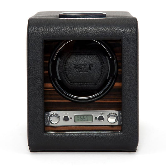 A WOLF 1834 Roadster Single Winder, crafted with leather and wood, features a digital display reminiscent of British motorcars and includes two control knobs. The central compartment elegantly displays the WOLF brand name. The digital screen shows "5:50," exuding a design as sleek and modern as a classic roadster.