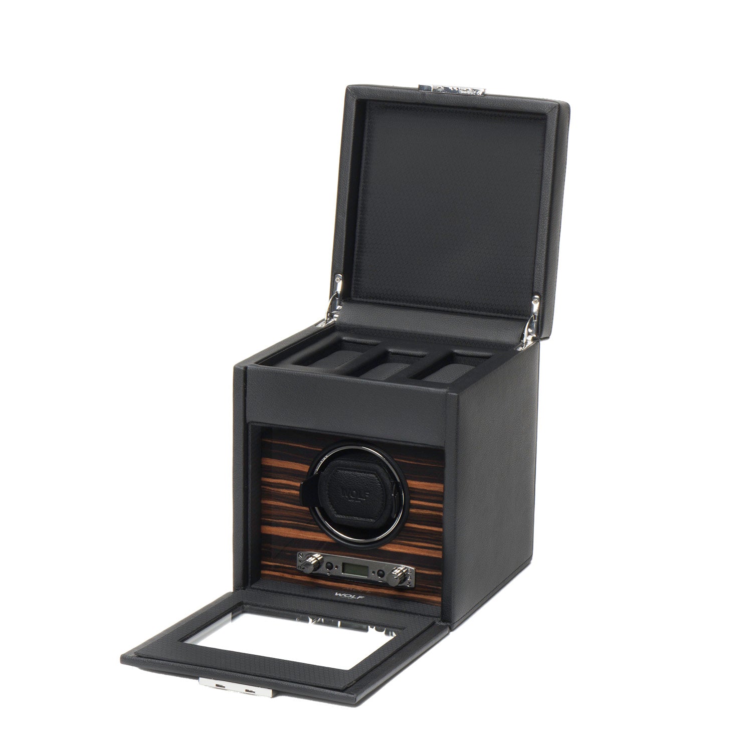 Discover the WOLF 1834 Roadster Single Watch Winder With Storage, a stylish black winder showcasing a rectangular design and wood finish interior with compartments for multiple watches. Enhanced with vegan leather accents, the lid and front panel elegantly display the sophisticated winding mechanism within. Crafted by WOLF.