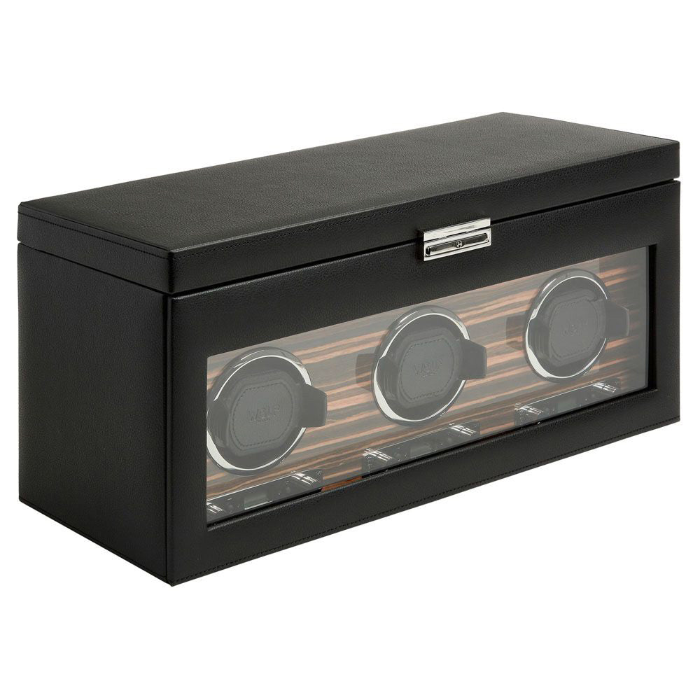 Introducing the WOLF 1834 Roadster Triple Watch Winder With Storage: a sophisticated black leather box featuring a transparent front panel to showcase three compartments for your wristwatches. The interior is elegantly finished with dark wood, with each compartment equipped with a circular holder to automatically wind your watches and manage their power reserve setting.