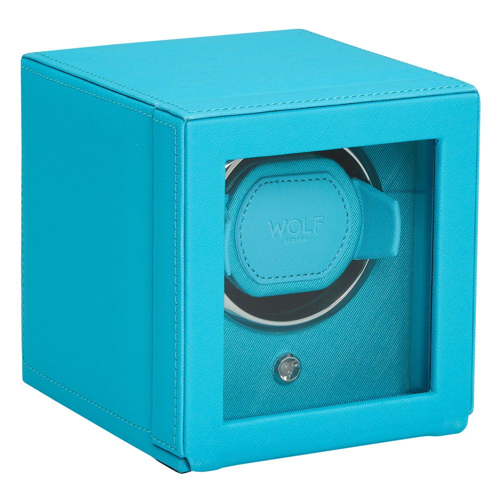 The WOLF 1834 Cub Single Watch Winder in turquoise features vegan leather, a glass front, silver trim, a lock, and the WOLF brand name on the interior.
