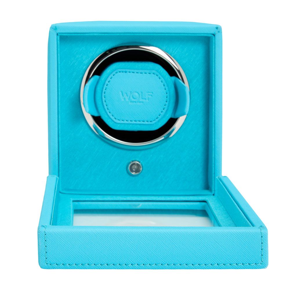 The WOLF 1834 Cub Single Watch Winder in turquoise vegan leather features a circular holder, patented rotation mechanism, glass lid, and "WOLF" branding inside.