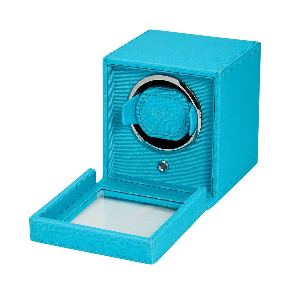 The WOLF 1834 Cub Single Watch Winder in turquoise vegan leather features an open glass lid, a circular holder with patented rotation, and a silver front button. The "WOLF" brand is visible inside.