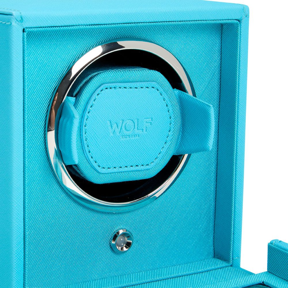 Close-up of the WOLF 1834 Cub Single Watch Winder Turquoise, crafted from vegan leather with a shiny silver circular trim. The WOLF logo and "EST. 1834" are embossed on the front strap that secures your watch.