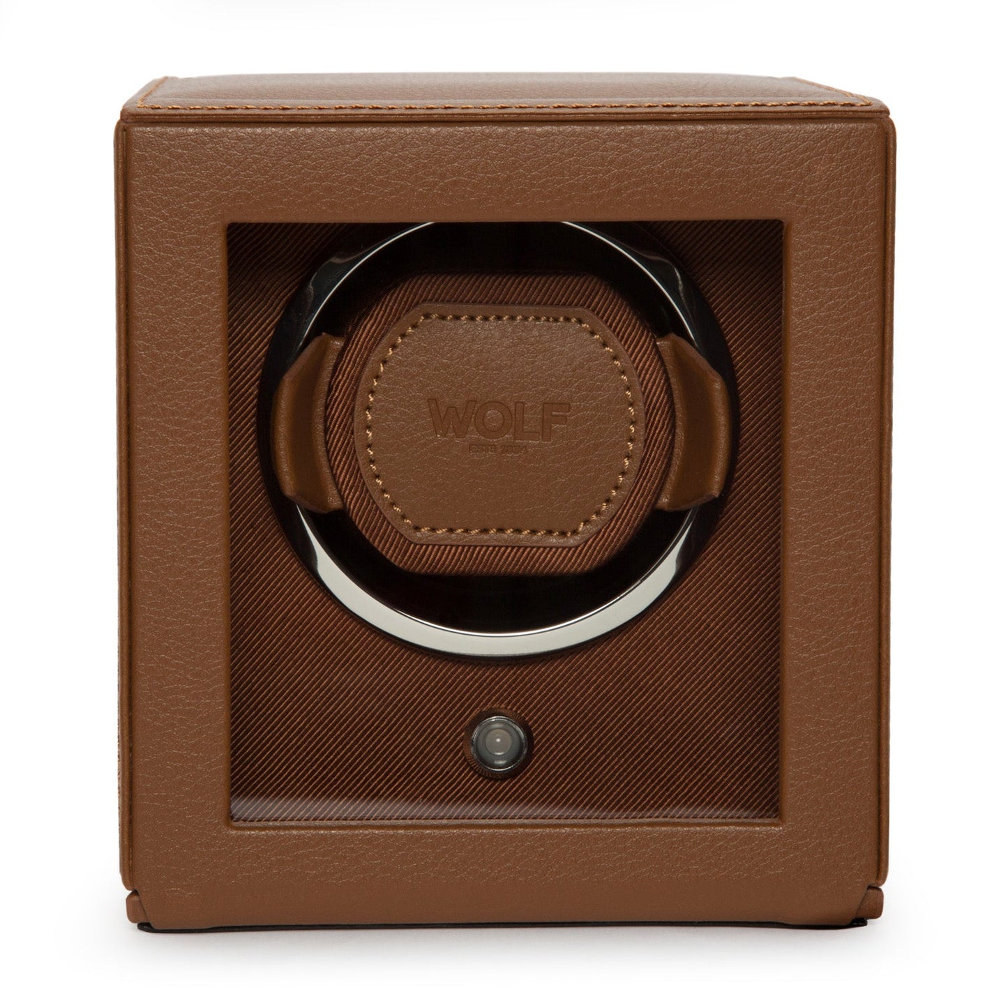 A WOLF 1834 Cub Single Watch Winder With Cover in brown leather offers luxury with its rotation programs and sleek design, featuring a transparent front panel that reveals the interior. The brand name "WOLF" is embossed on the leather inside.
