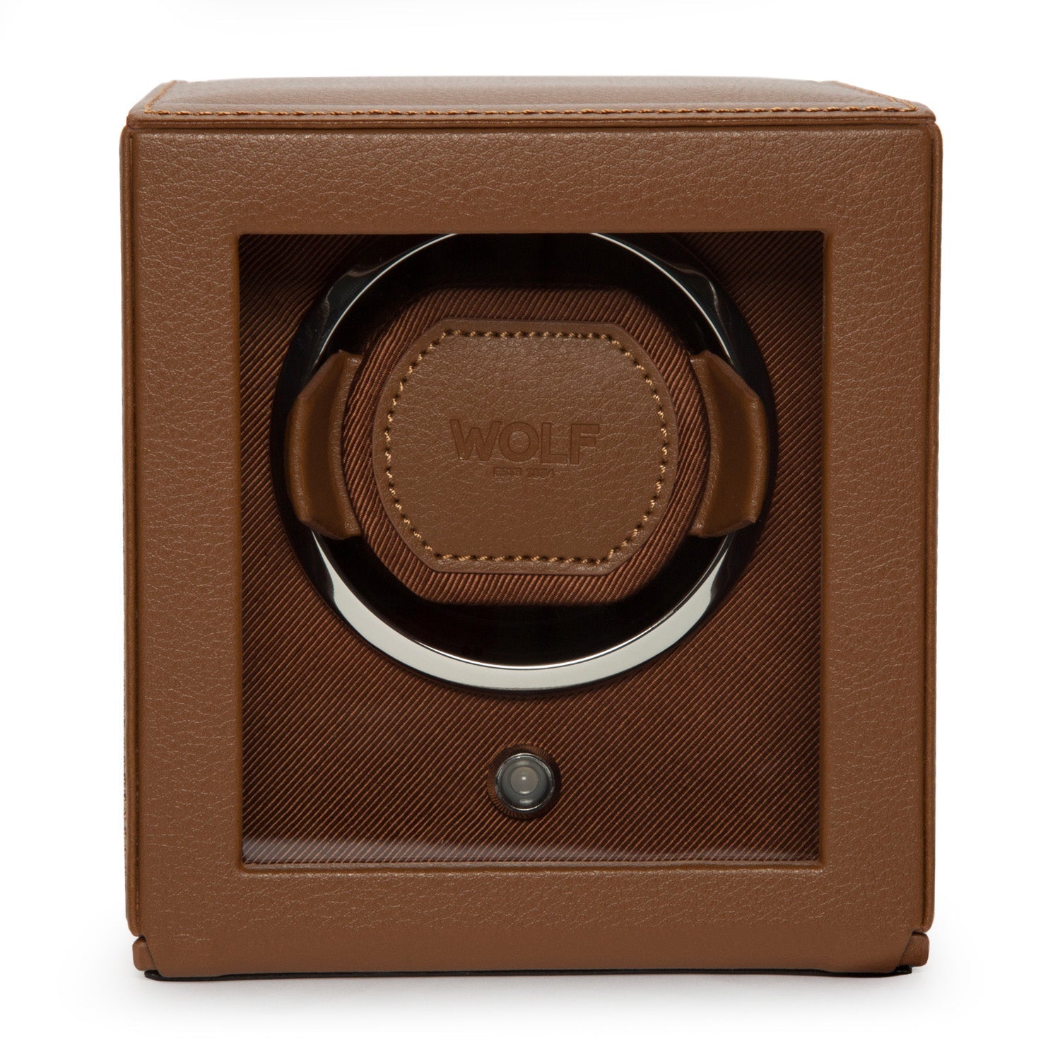 A WOLF 1834 Cub Single Watch Winder With Cover in brown leather offers luxury with its rotation programs and sleek design, featuring a transparent front panel that reveals the interior. The brand name "WOLF" is embossed on the leather inside.
