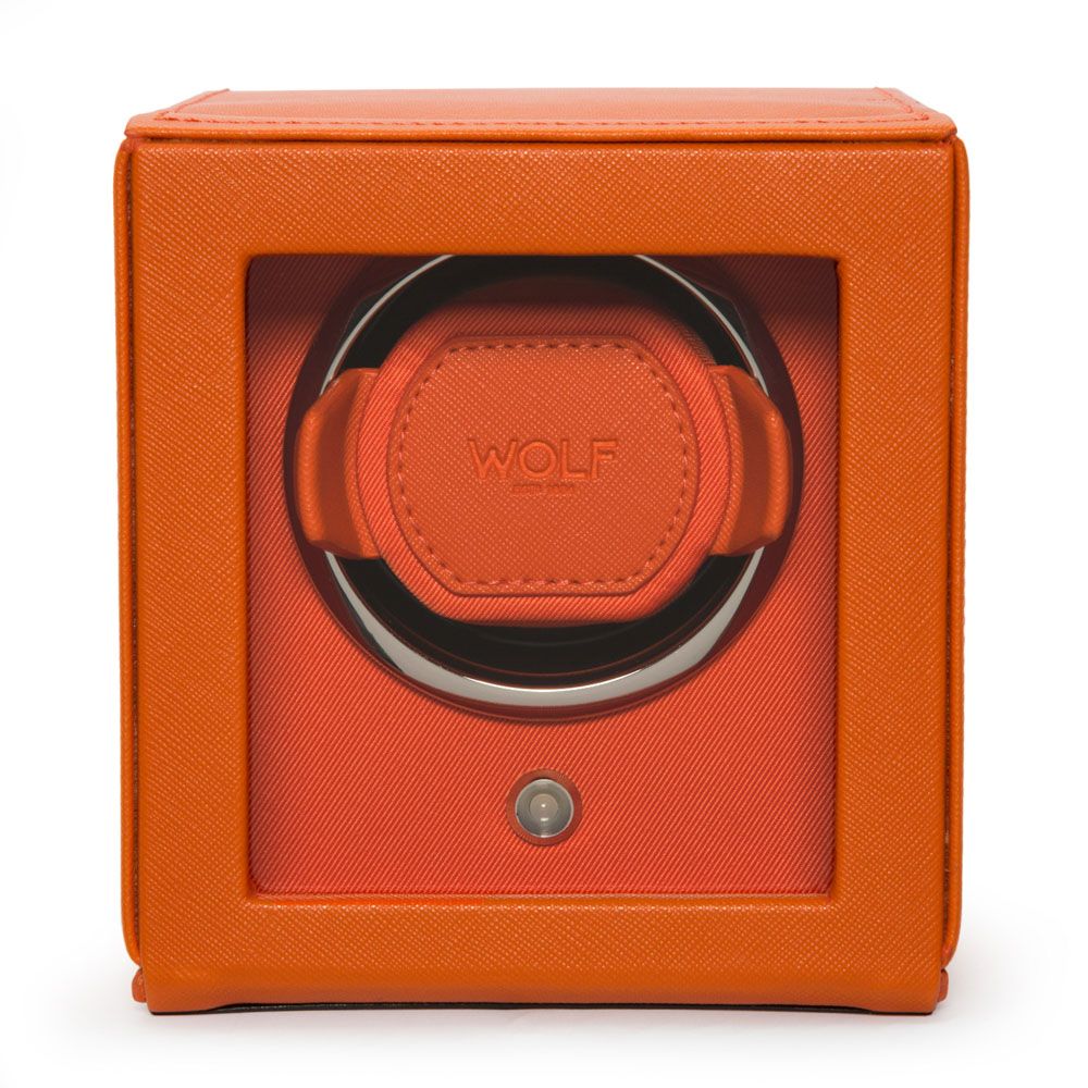 The WOLF 1834 Cub Single Watch Winder Orange is a square, orange vegan leather watch winder with a clear front window, a "WOLF" logo inside, patented rotation programs, circular watch holder, and a small button below the window.