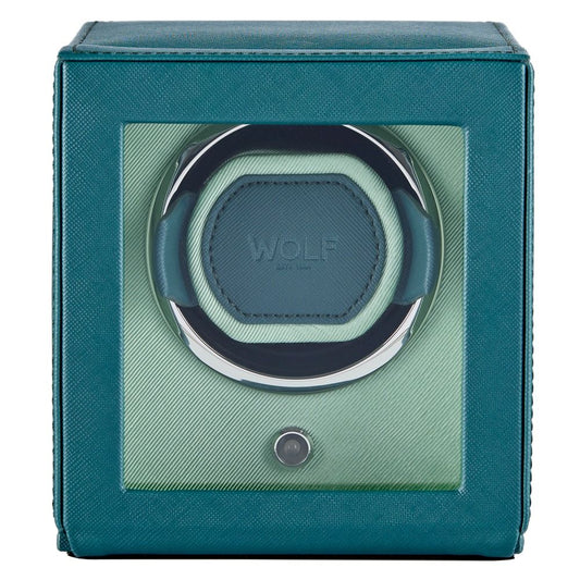 The WOLF 1834 Cub Single Watch Winder Teal by WOLF features a striking teal vegan leather exterior and a glass front display, showcasing a circular holder inside with a button positioned below the window. This elegant watch winder also incorporates WOLF’s patented rotation programs to ensure your timepiece remains perfectly wound.