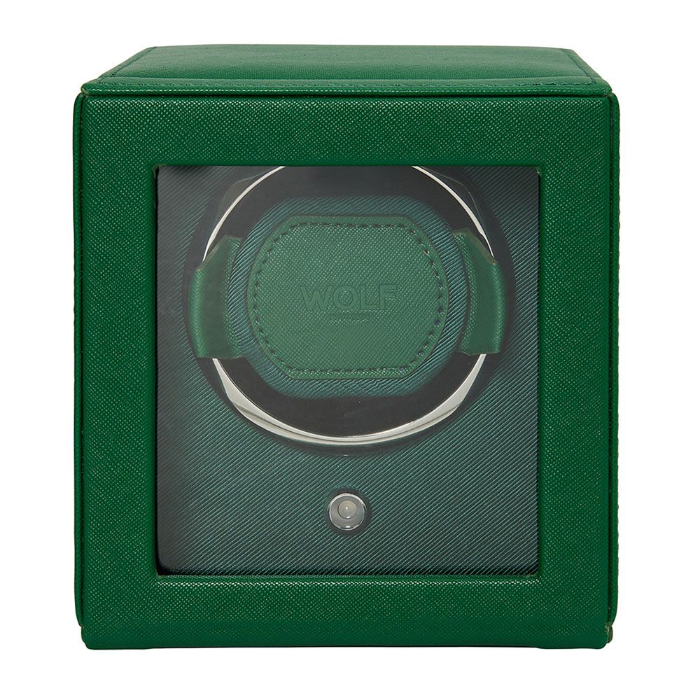 The WOLF 1834 Cub Single Watch Winder Green is a square, green watch winder made of vegan leather with a glass front. It features a circular patented holder, a small button below, and displays the "WOLF" brand name inside.