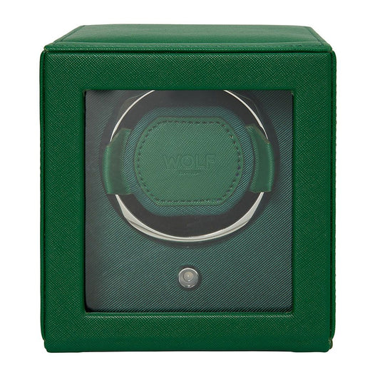 The WOLF 1834 Cub Single Watch Winder Green is a square, green watch winder made of vegan leather with a glass front. It features a circular patented holder, a small button below, and displays the "WOLF" brand name inside.