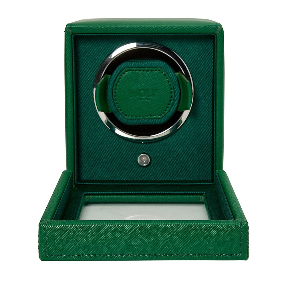 The WOLF 1834 Cub Single Watch Winder Green features vegan leather, a circular holder, "WOLF" embossed on the inner cushion, an open front door, and a glass base panel.