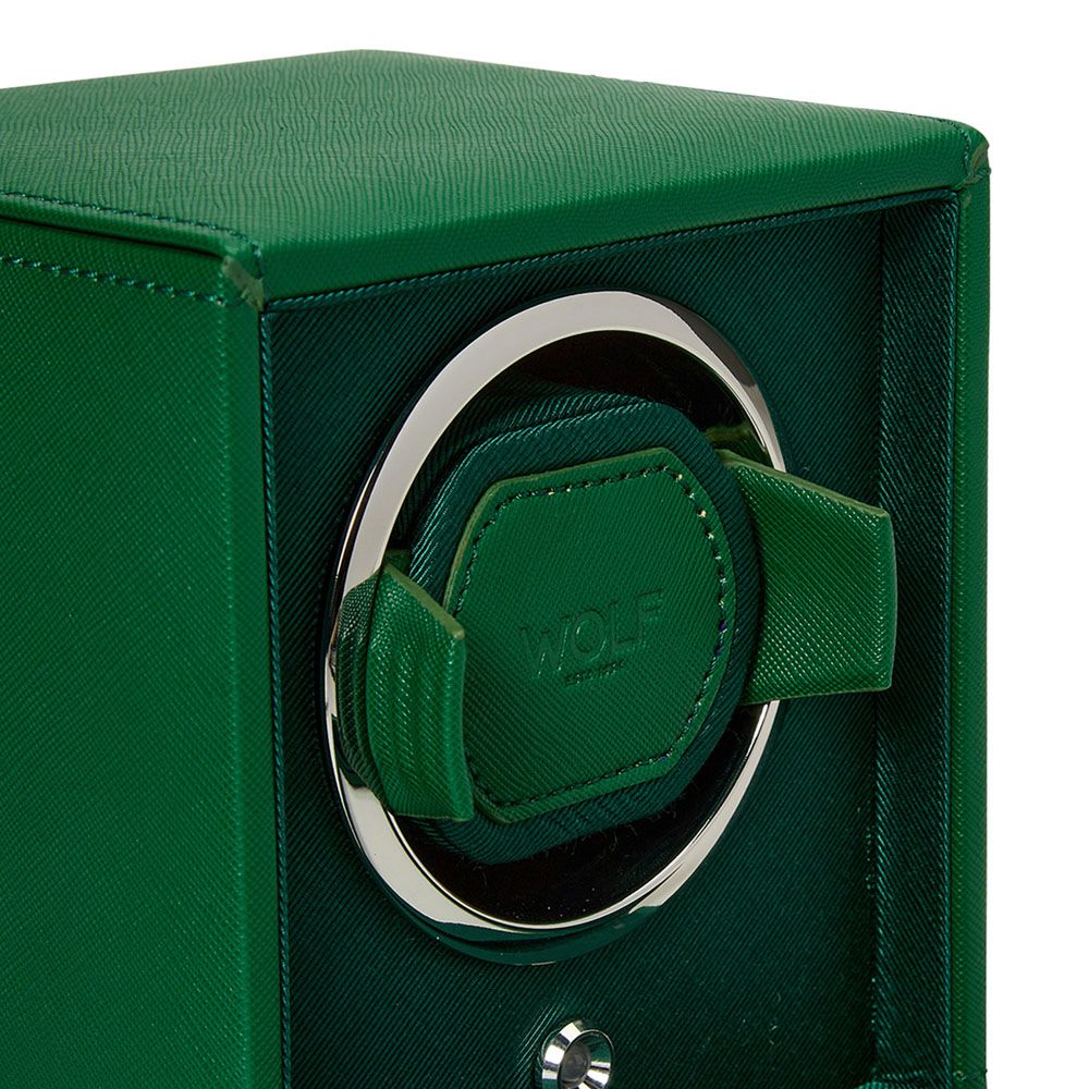 A close-up of the WOLF 1834 Cub Single Watch Winder in green vegan leather, featuring a textured finish, silver circular trim, and a padded central watch holder.