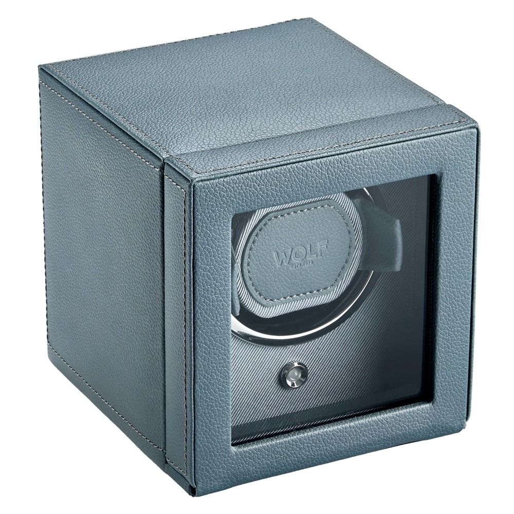 A WOLF 1834 Cub Single Watch Winder in grey vegan leather, featuring a glass front panel, metallic interior, and the “WOLF” brand name displayed inside.