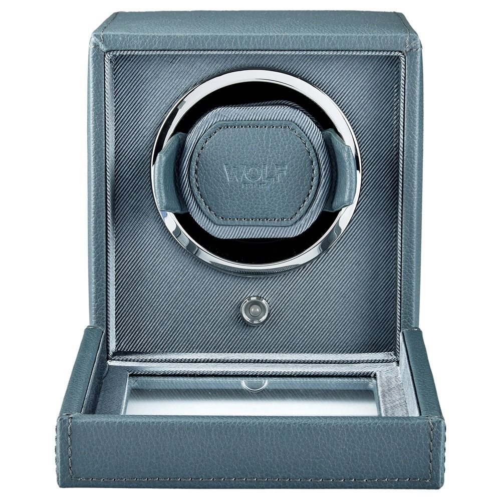 The WOLF 1834 Cub Single Watch Winder in grey features vegan leather construction with a circular compartment, silver trim, and the WOLF logo embossed at the center. The open front panel reveals a glass-bottom tray.