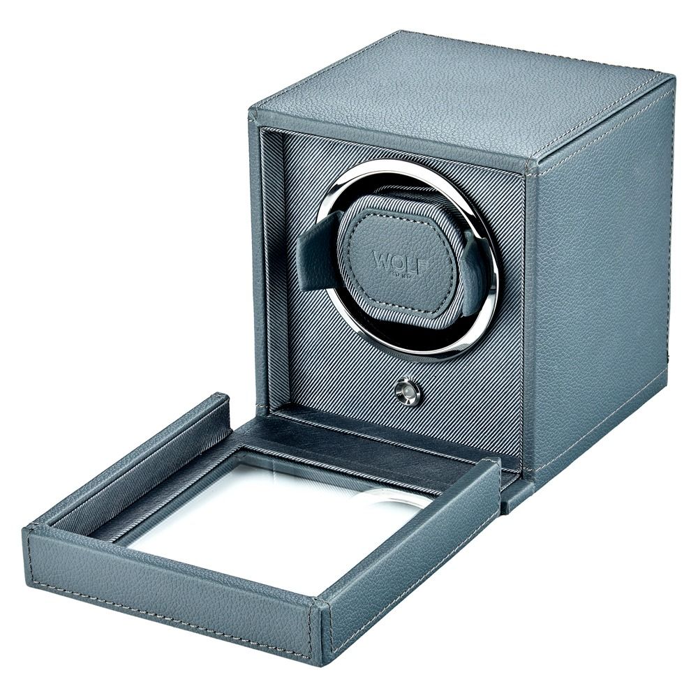 The WOLF 1834 Cub Single Watch Winder in Grey features vegan leather and a glass door, revealing the interior watch holder with a round chrome accent.