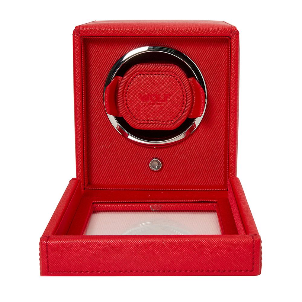 The WOLF 1834 Cub Single Watch Winder in red vegan leather features a circular center opening, chrome accents, an embossed "WOLF" logo inside, visible rotation programs, and a transparent display panel at the base.