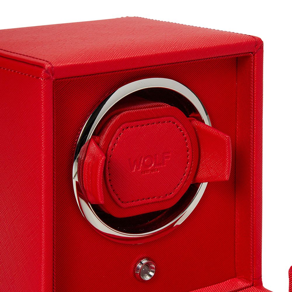 A close-up of the WOLF 1834 Cub Single Watch Winder in red vegan leather, showcasing a padded holder with "WOLF" embossed. Both the interior and exterior are red with metallic accents and offer multiple rotation programs.