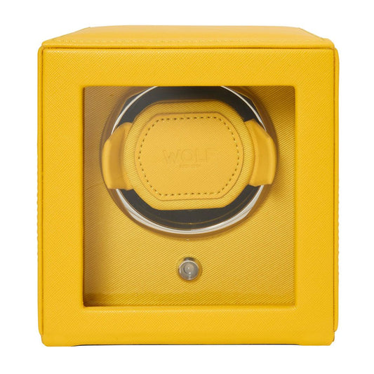The WOLF 1834 Cub Single Watch Winder Yellow features a vegan leather, cube-shaped design with a transparent front panel, embossed WOLF logo, and patented rotation programs for optimal watch care.
